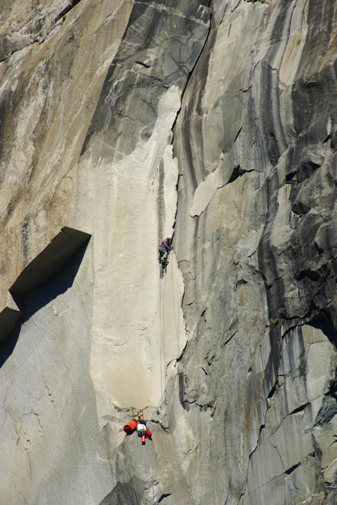 Ryan leading the wide, thin flake on P14.  Scary!  Photo by Tom Evans.